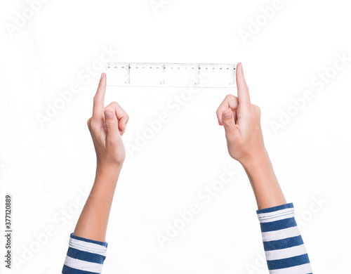 child's hand holding a ruler, white background