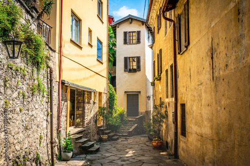 Fototapeta Naklejka Na Ścianę i Meble -  Gandria village scenic laneway with colorful houses and dramatic light in Gandria Ticino Switzerland