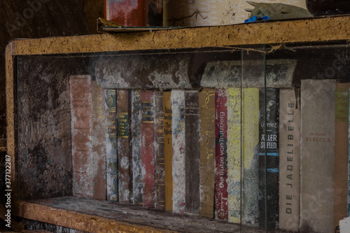 old moldy books in a glass display case