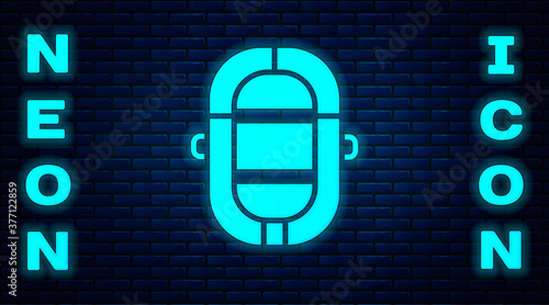 Glowing neon Rafting boat icon isolated on brick wall background. Inflatable boat. Water sports, extreme sports, holiday, vacation. Vector Illustration.