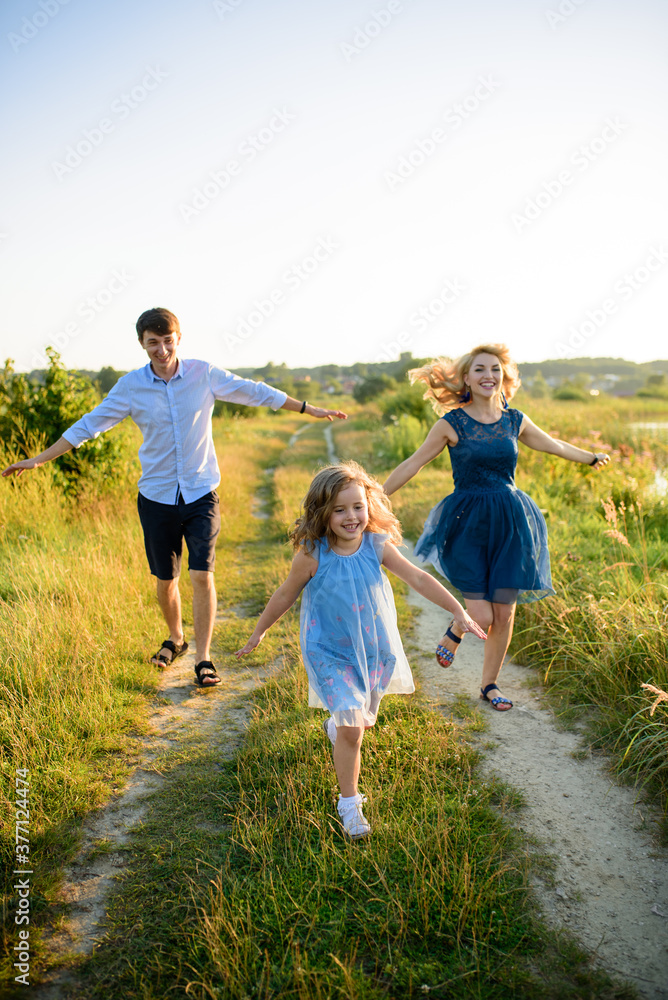 Dad mom and daughter have fun together in nature. Dad mom and daughter have fun together in nature.