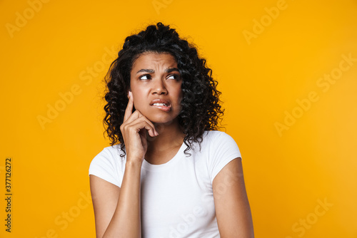 Image of unhappy african american woman posing and looking aside