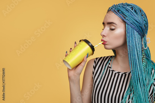 Portrait of a bright young woman on a yellow background photo