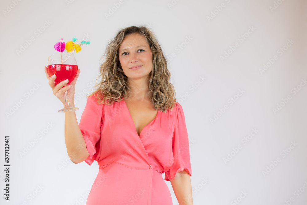 Smiling beautiful woman in pink dress with a cocktail Smiling beautiful woman in pink dress with a cocktail