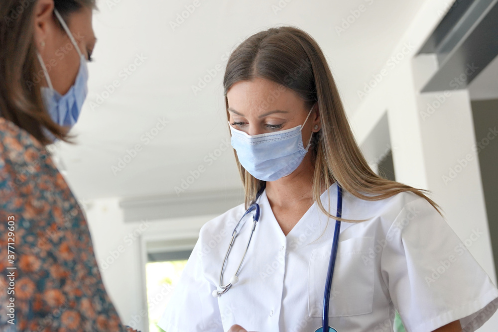 Physiotherapist with patient, wearing face mask Physiotherapist with patient, wearing face mask