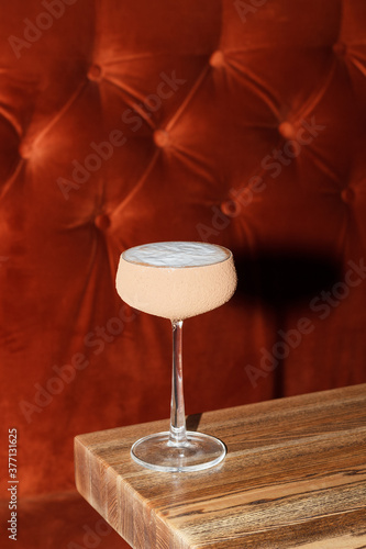 Cocktails in a glass on a red corduroy background. Restaurant, bar. Luxury concept.
