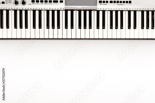 Musician work set with synthesizer  note and headphones Yellow table background top view space for text