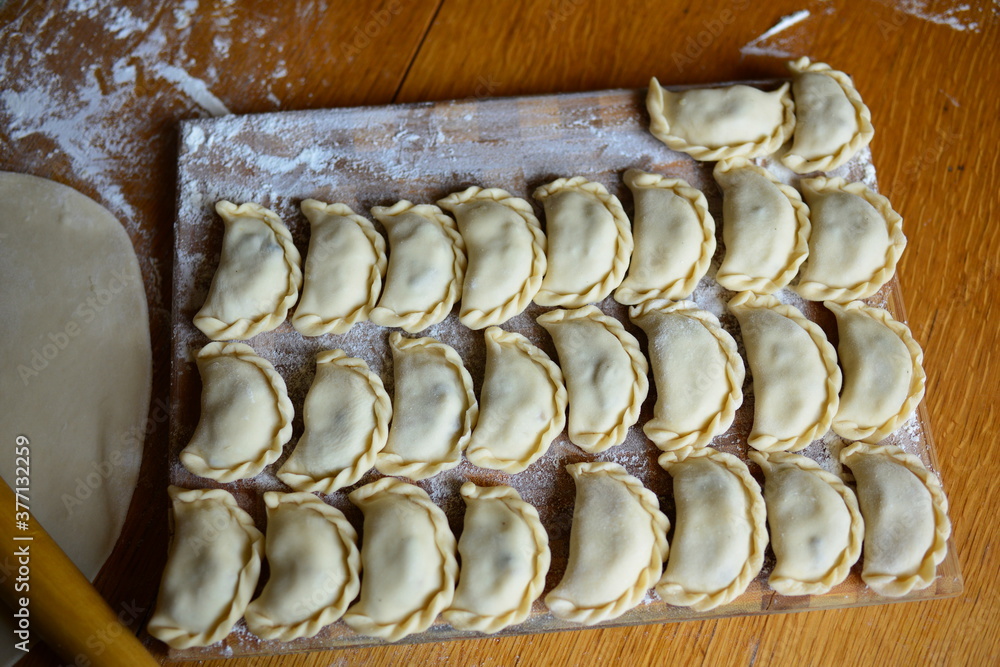 Fototapeta premium Raw materials for making Pierogi with potatoes, which are prepared for cooking