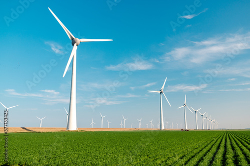 offshore windmill park with stormy clouds and a blue sky, windmill park in the ocean. Netherlands Europe
