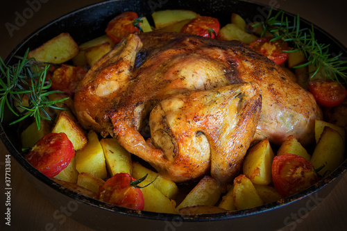 Chicken baked with potatoes and tomato