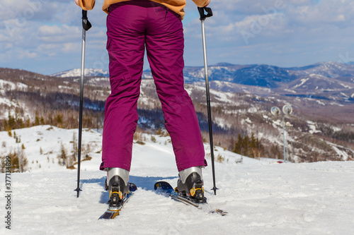 legs and view from behind the skier on the mountain photo