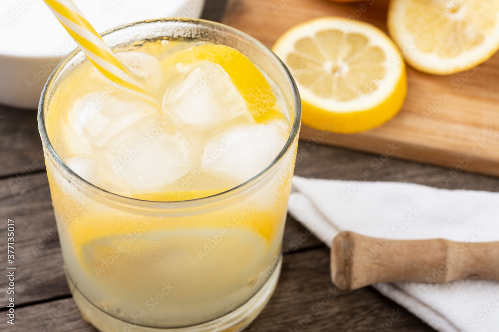 Brazilian sicilian lemon caipirinha in a glass with ice with fruit slices over wooden board Brazilian sicilian lemon caipirinha in a glass with ice with fruit slices over wooden board