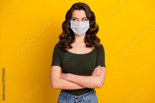 Portrait of her she nice attractive content healthy wavy-haired girl folded arms wearing safety mask stop viral pneumonia pandemia isolated bright vivid shine vibrant yellow color background
