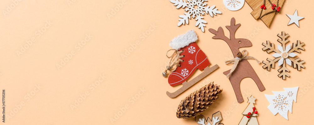 Top view of New Year toys and decorations on orange background. Christmas time concept Banner with empty space for your design