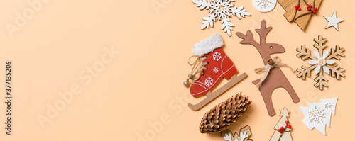 Top view of New Year toys and decorations on orange background. Christmas time concept Banner with empty space for your design