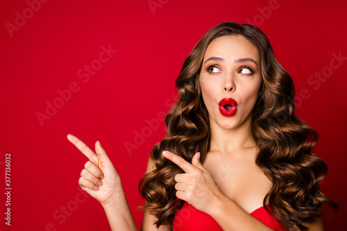 Closeup photo of attractive beautiful curly lady model open mouth advertising underwear direct fingers side empty space wear brassiere isolated red color background