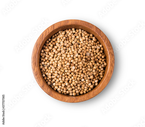Dried coriander seeds top view on white background