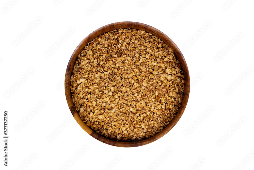 Brown dried uncooked buckwheat flakes in round wooden bowl isolated on white background. Brown dried uncooked buckwheat flakes in round wooden bowl isolated on white background.