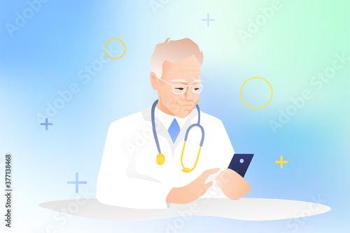 An elderly male doctor sits at a table with a smartphone and consults patients online. Grandpa in glasses and a white robe with a mobile. Medical staff concept.