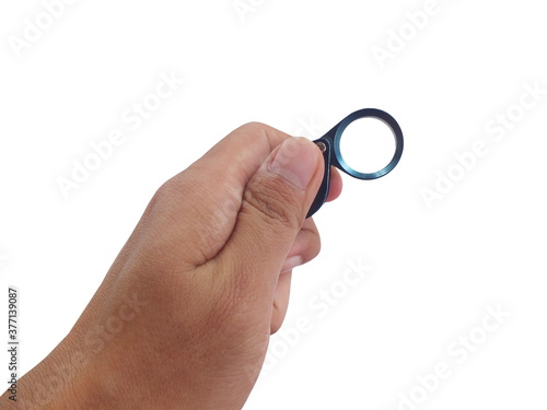 Hand holding magnifying glass for diamonds. or see the amulet. Isolated on white background.