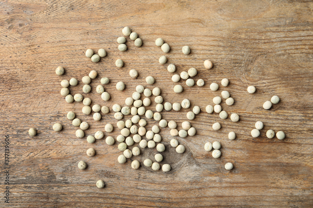 Raw dry peas on wooden background, flat lay. Vegetable seeds Raw dry peas on wooden background, flat lay. Vegetable seeds