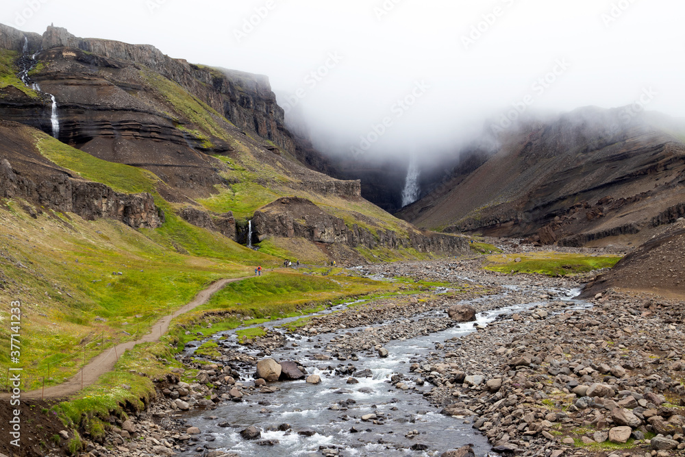 Mystical view of Hengifoss waterfall in a cloud, east Iceland. Summer hike. Mystical view of Hengifoss waterfall in a cloud, east Iceland. Summer hike.