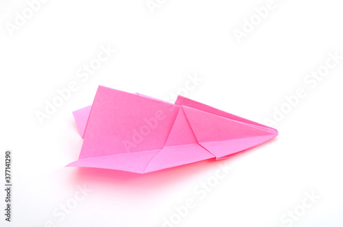 A pink paper airplane on white background with clipping path