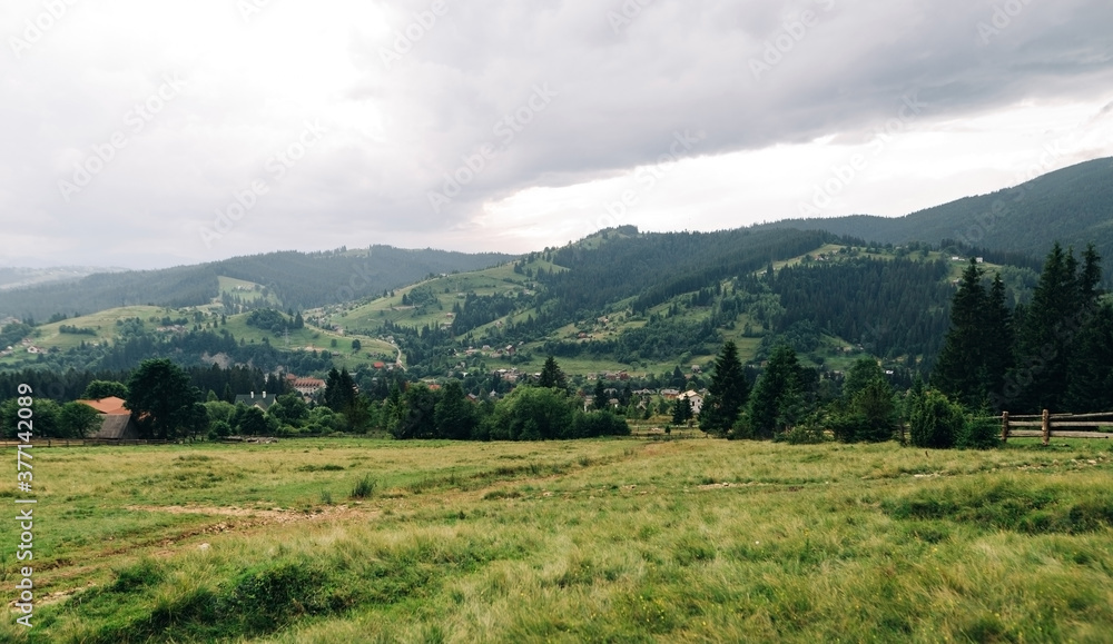 Landscape of the mountain village of Vorokhta, Carpathians from the meadow. Beautiful mountain village on a cloudy day. Travel to Ukraine Landscape of the mountain village of Vorokhta, Carpathians from the meadow. Beautiful mountain village on a cloudy day. Travel to Ukraine
