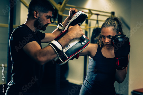 woman boxing training with her trainer