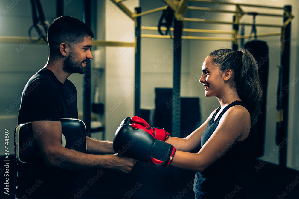 handshake woman with her trainer in gym