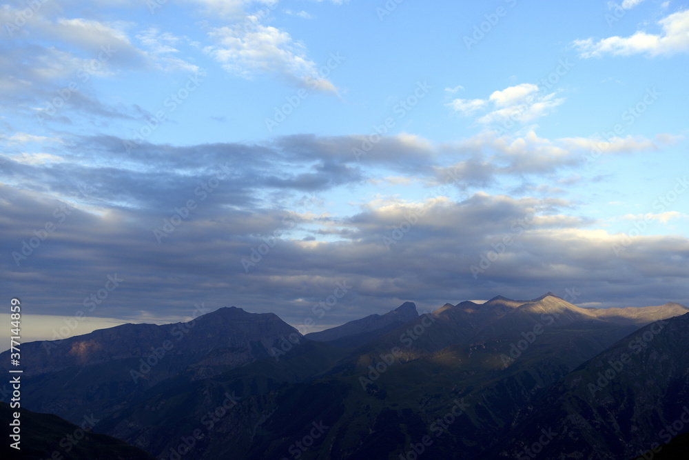 Mountain ranges at sunset. Dusk.
Silhouettes of mountains in the evening haze. Mountain ranges at sunset. Dusk.