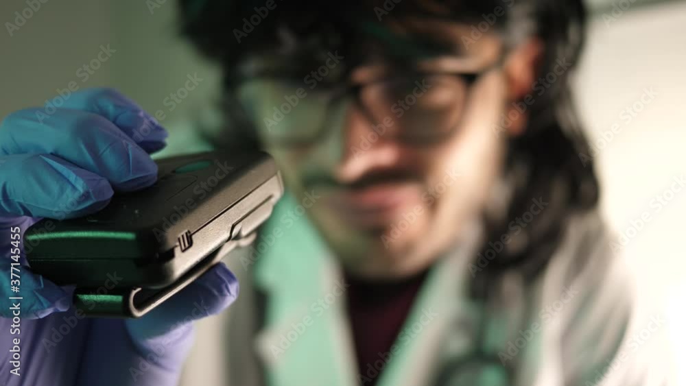 80s 90s vintage pager beeper being used by a doctor or nurse wearing a