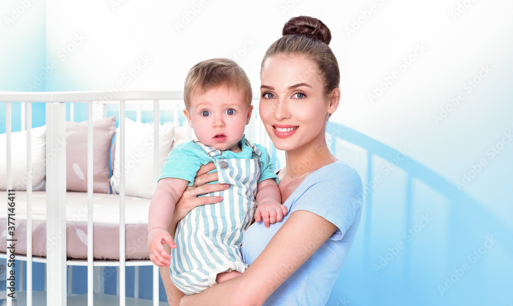 Mother and baby playing and smiling. Happy family.Home interior. Mother and baby playing and smiling. Happy family.Home interior.