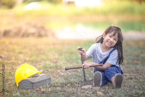 A close-up view of a cute Asian girl. Who are simulating learning outside of the classroom, event planning, designing on the mechanic