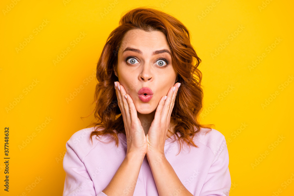 Closeup photo of beautiful ginger lady open mouth listen amazing news arms on cheeks wear pink pullover shirt isolated yellow color background Closeup photo of beautiful ginger lady open mouth listen amazing news arms on cheeks wear pink pullover shirt isolated yellow color background