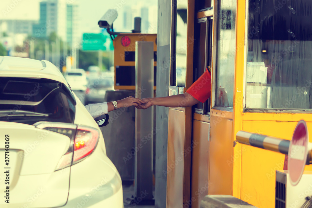 Driver pay for the expressway. Woman pays money to a cashier for a toll