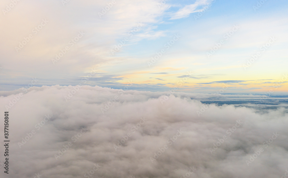 Aerial view clouds over the forest and lake . View from drone. Aerial top view cloudscape. Texture of clouds. View fog over forest from above.
