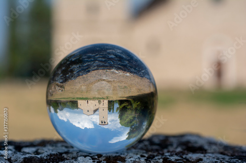 Background with ancient abbey of San Vincenzo seen through a crystal ball, central Italy landscapes.
