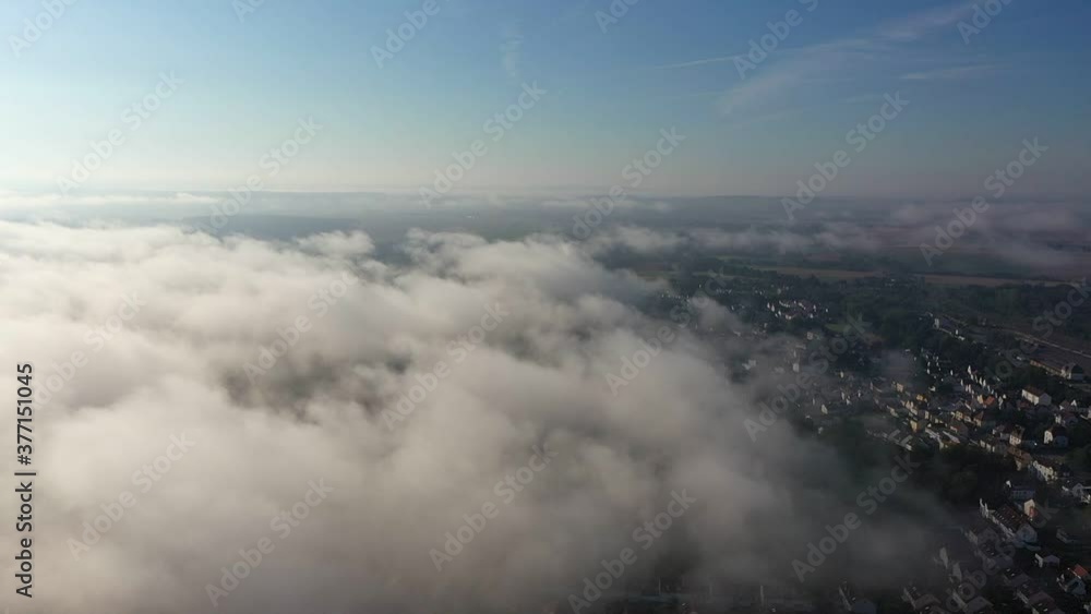 A village in Germany, surrounded by very thick fog. camera movement from top to bottom A village in Germany, surrounded by very thick fog. camera movement from top to bottom
