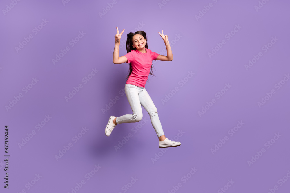 Full body photo of positive kid girl jump make selfie wear pink white pants isolated over violet color background