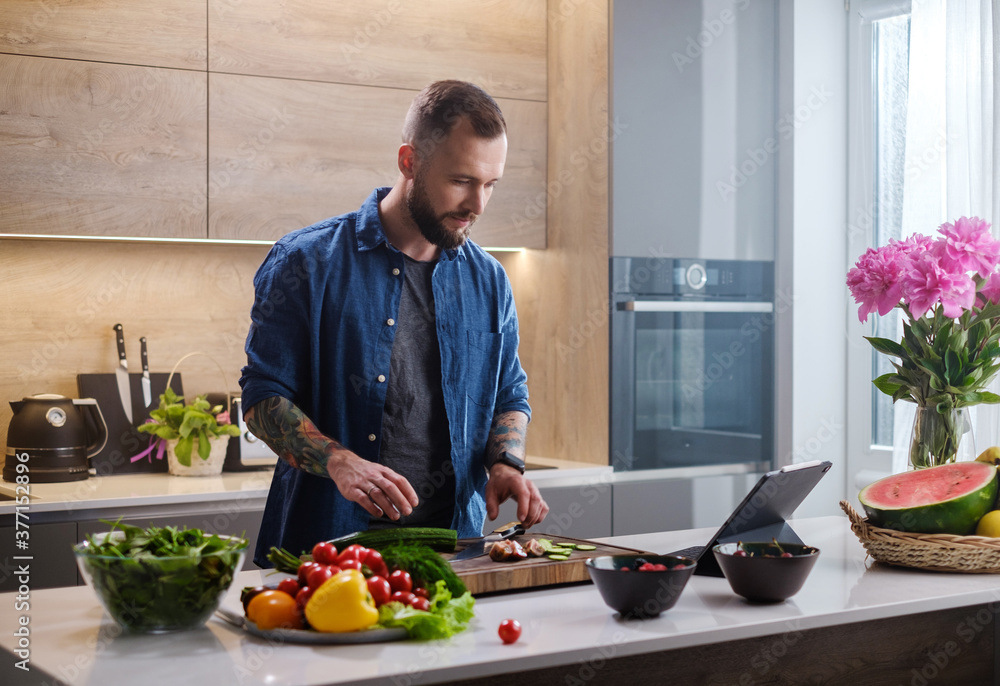 Focused Man Watch Recipe From Tablet . Focused Man Watch Recipe From Tablet .