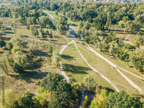 Aerial drone view. Dirt path in the city park