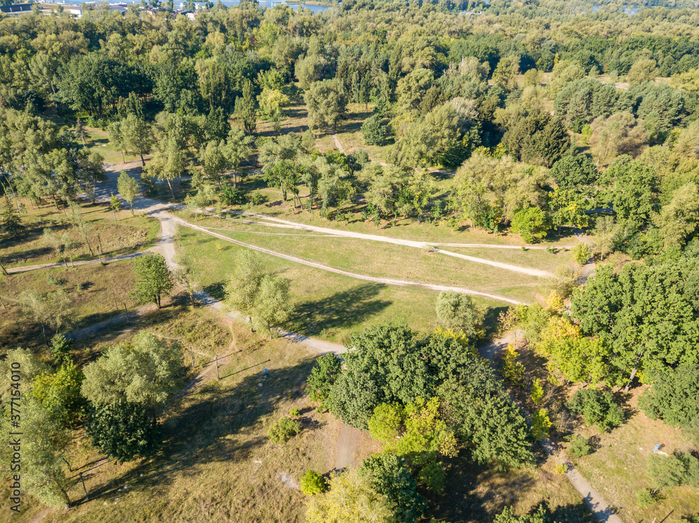 Aerial drone view. Dirt path in the city park