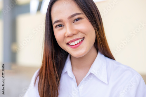 Portrait of beautiful young Asian woman smiling and looking to camera