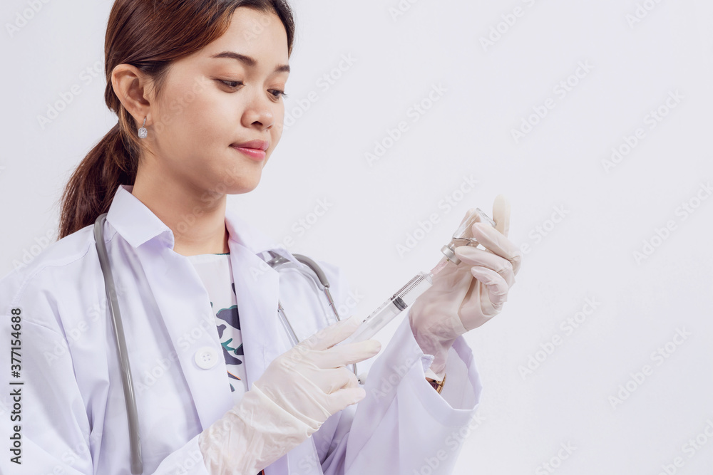 Asian female doctor with vial and syringe isolated on white background Asian female doctor with vial and syringe isolated on white background