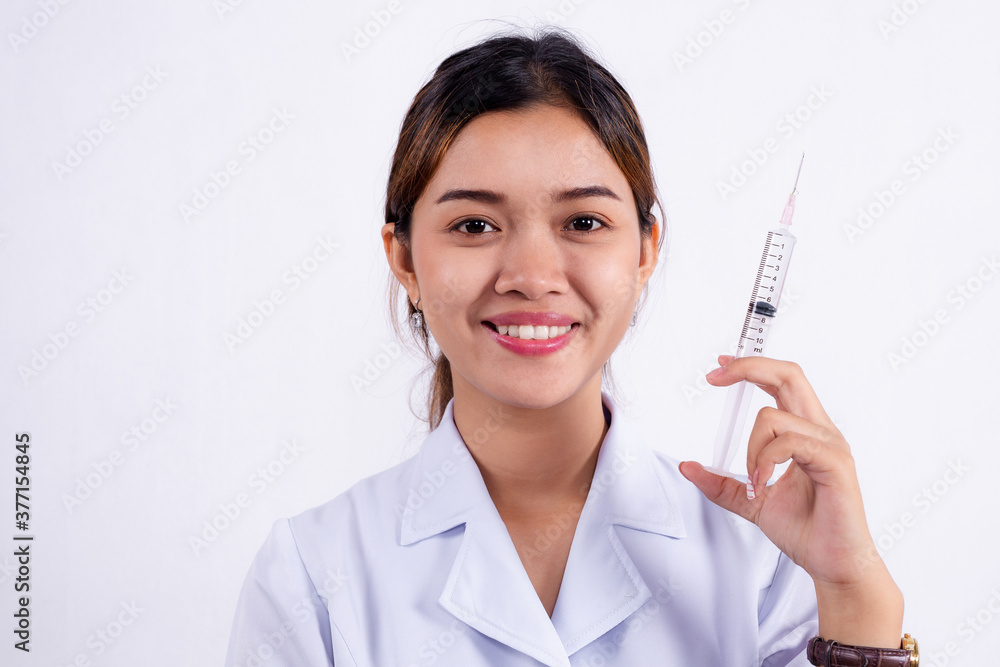 Smiling, portrait of Asian female doctor holding a syringe isolated on the white background Smiling, portrait of Asian female doctor holding a syringe isolated on the white background