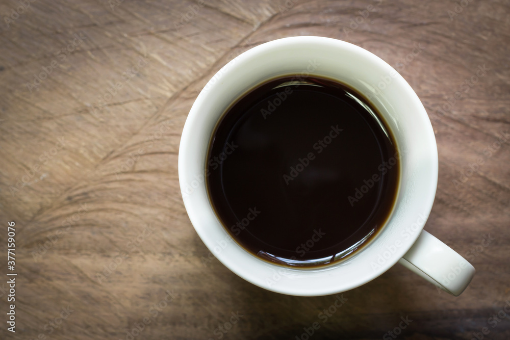 Cup of black coffee on wooden table background with copy space. Cup of black coffee on wooden table background with copy space.