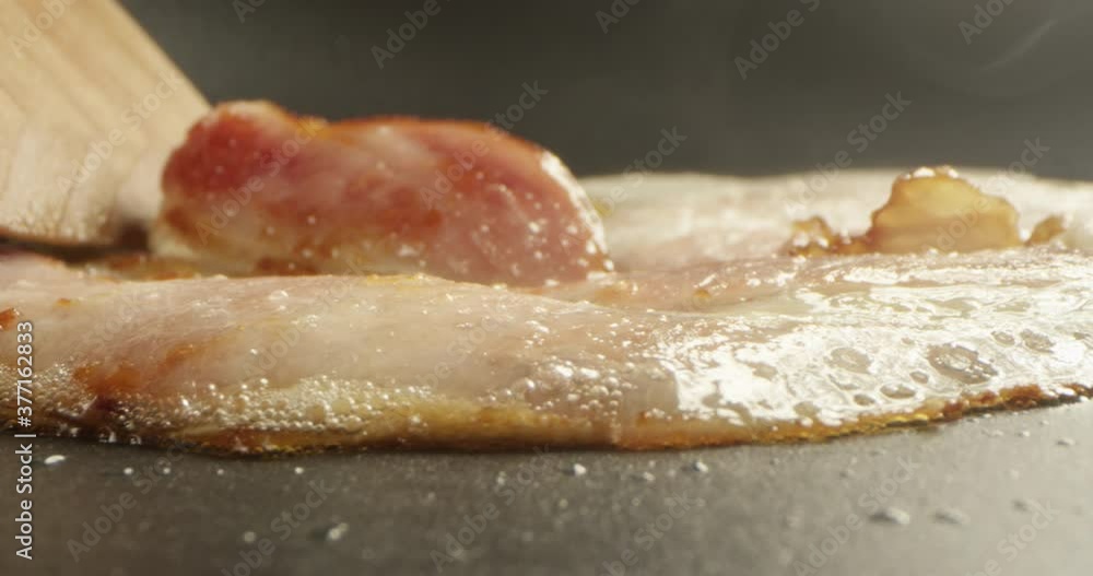 Slice of Bacon on a Frying Pan a Closeup Shot on Red Camera
Slice of Bacon on a Frying Pan a Closeup Shot on Red Camera