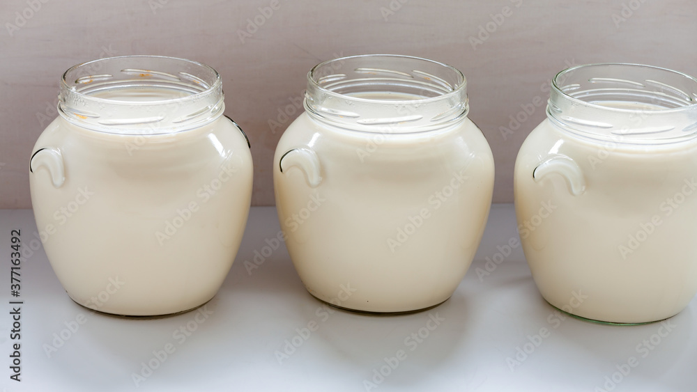 Jars with freshly made soy milk. Homemade vegan plant milk. Asian cuisine. Jars with freshly made soy milk. Homemade vegan plant milk. Asian cuisine.