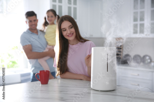Family in kitchen with modern air humidifier